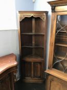 An oak linenfold corner cabinet