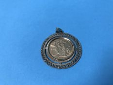 A sovereign, dated 1976, in a 9ct gold mount, 12g total
