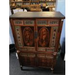 An Oriental four door cabinet