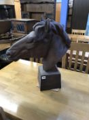 A cast bust of a horses head