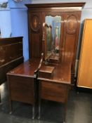 An Edwardian mirror door wardrobe, dressing table and chest