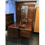 An Edwardian mirror door wardrobe, dressing table and chest