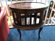 A reproduction mahogany oval display cabinet