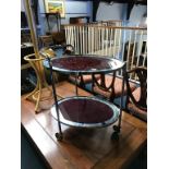 A chrome two tier oval tea trolley