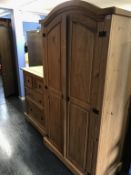 A pine wardrobe and pine chest of drawers