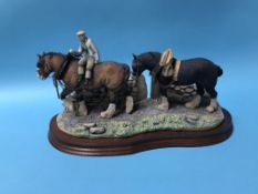 A Border Fine Arts Group of a Man leading two Shire Horses, 36cm wide