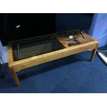 A teak tiled and glass coffee table