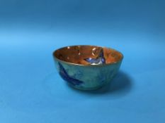 A small lustreware circular bowl, decorated with birds and butterflies, 11cm diameter