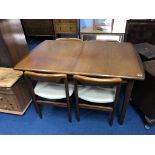 A teak extending dining table and four chairs