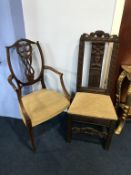 A carved chair and an Edwardian chair