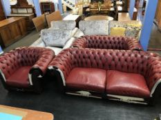 A Chesterfield oxblood and hide three seater settee, two seater settee, Club armchair and a
