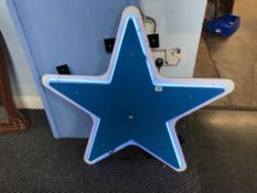 A blue plastic star shaped neon sign, 91cm wide