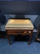 An Edwardian upholstered piano stool