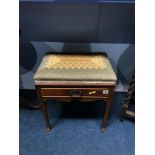 An Edwardian upholstered piano stool