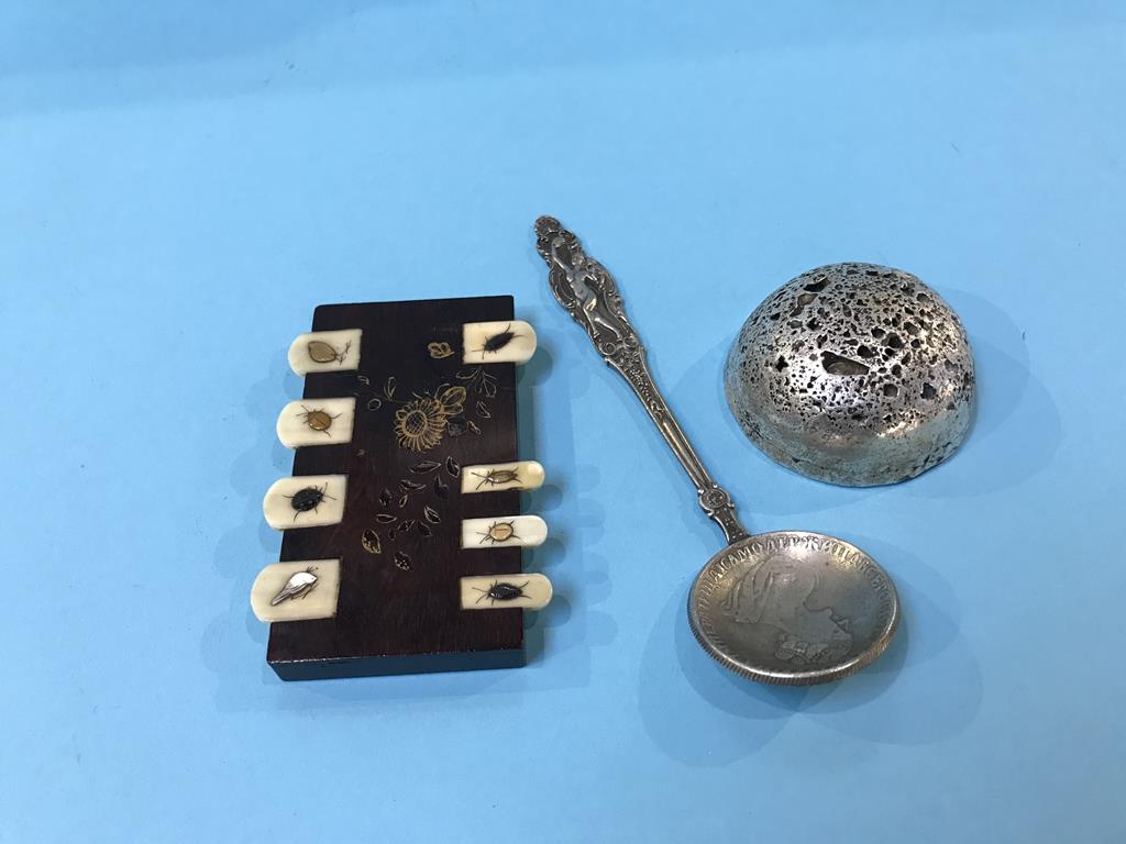 A game counter, paperweight and a caddy spoon