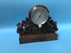 A carved walnut table barometer, by M Pillischer, 88 New Bond Street, London, 34cm wide