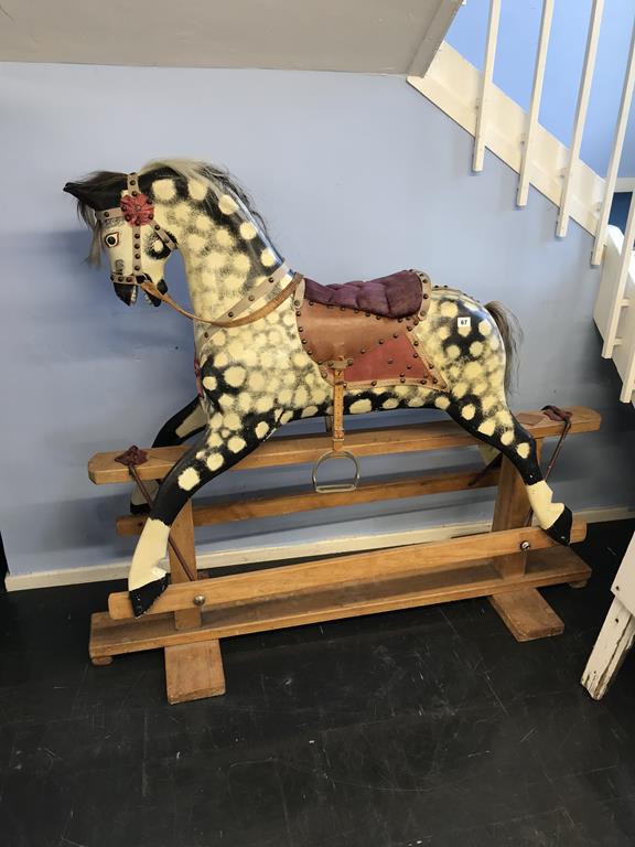 A dapple grey child's rocking horse on stand