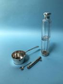 A silver pan, pencil and scent bottle
