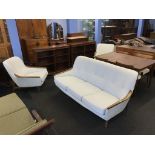 A teak framed three seater settee and a pair of armchairs (possibly Swedish)