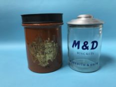 A tobacco jar and cover 'Best Shag' and an M and D Biscuits tin 'Meredith and Drew' (2)