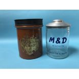 A tobacco jar and cover 'Best Shag' and an M and D Biscuits tin 'Meredith and Drew' (2)