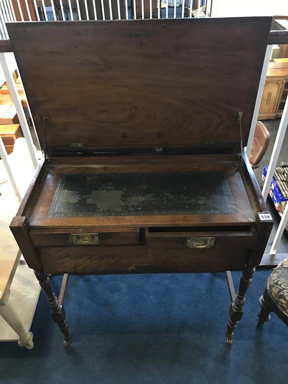 An Edwardian walnut Campaign writing desk with rising top, inset leather interior, with two drawers,