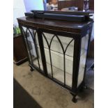 A mahogany bow front china cabinet