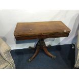 A 19th century mahogany fold over card table