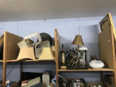 A quantity of lampshades and lamps in two shelves