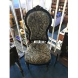 A Victorian ebonised nursing chair