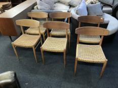 A set of six Danish A. M. Mobler 501 oak single dining chairs, with rush work seats