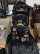 A Harley Davidson bag and leather waistcoat with patches