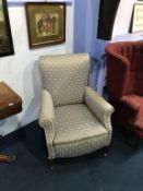 A pair of grey upholstered wing armchairs