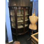 A mahogany bow front china cabinet