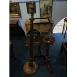 A half moon table, standard lamp and plant pedestal