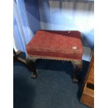 A mahogany claw and ball stool