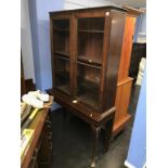 A mahogany china cabinet on stand