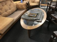 A teak oval Astro coffee table
