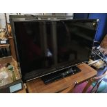 A Sharp TV, with remote