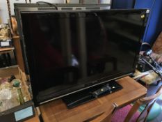 A Sharp TV, with remote