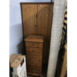A pine wardrobe and narrow pine chest of drawers