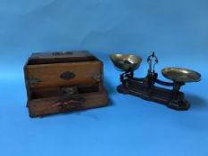 An Edwardian oak games box, with sliding lid, pull out drawer and pierced brass mounts and a set