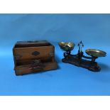 An Edwardian oak games box, with sliding lid, pull out drawer and pierced brass mounts and a set