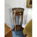 A walnut two tier circular pedestal