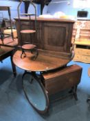 An oak gateleg table, oval mirror, Sutherland table, cake stand and two door cabinet