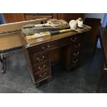 A reproduction mahogany knee hole desk