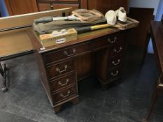 A reproduction mahogany knee hole desk