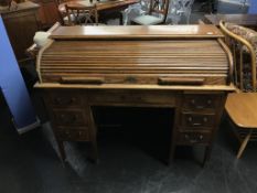 An oak tambour fronted desk