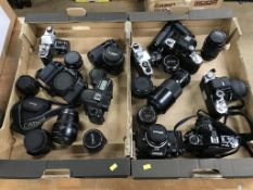Two trays of cameras and lenses, to include Canon, Nikon and Pentax