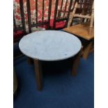 A teak and marble circular table